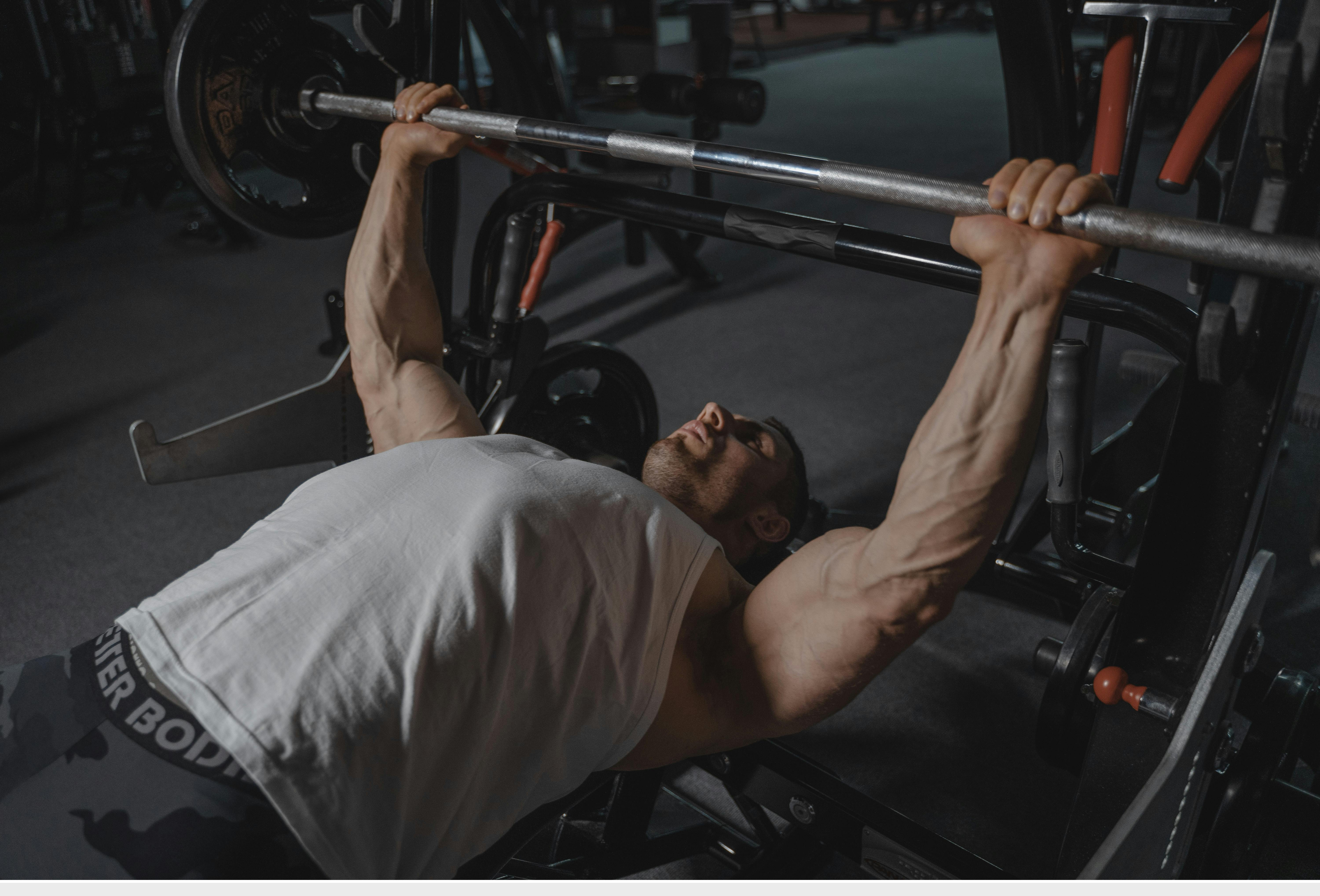 A man demonstrating high levels of strength in the gym while taking RAD-140